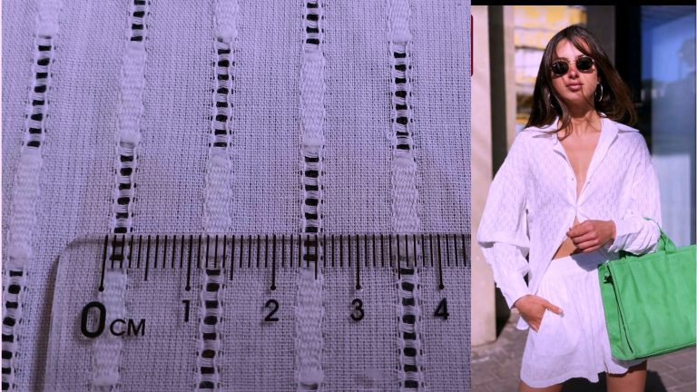 Close-up of white cotton jacquard fabric with hollow stripe pattern and detailed texture.
