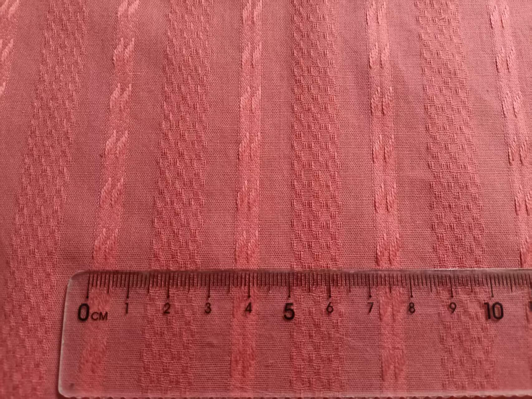 Jacquard fabric with transparent ruler showing repeat measurement