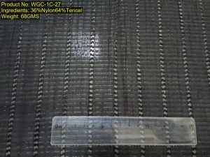 WGC-1C-27 36% nylon 64% Tencel small jacquard fabric with vertical stripe texture and semi-sheer woven surface, shown with ruler reference